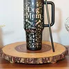 Engraved stainless steel dog mom tumbler with pet names and pictures, perfect for dog lovers.