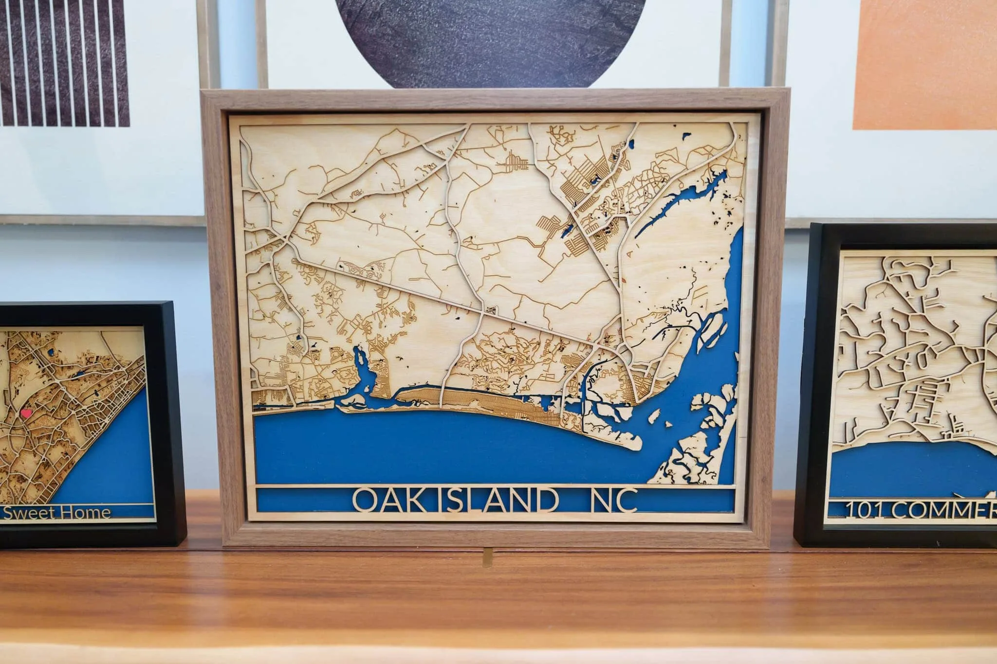 Laser cut map of Oak Island, NC in wood with blue water accents.