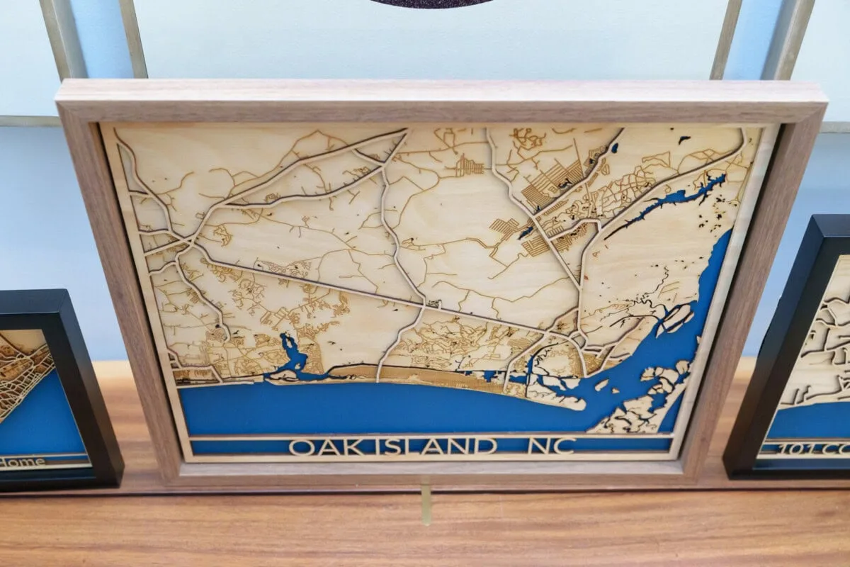Laser cut map of Oak Island, NC in wood with blue water accents.