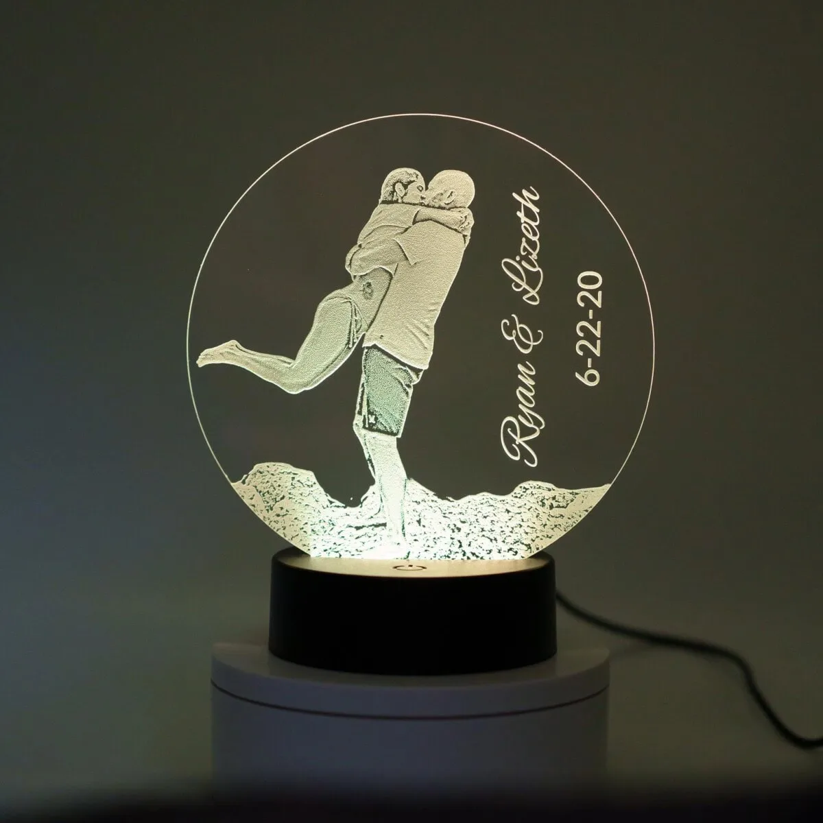 Personalized 3D LED night light with couple's names and date.
