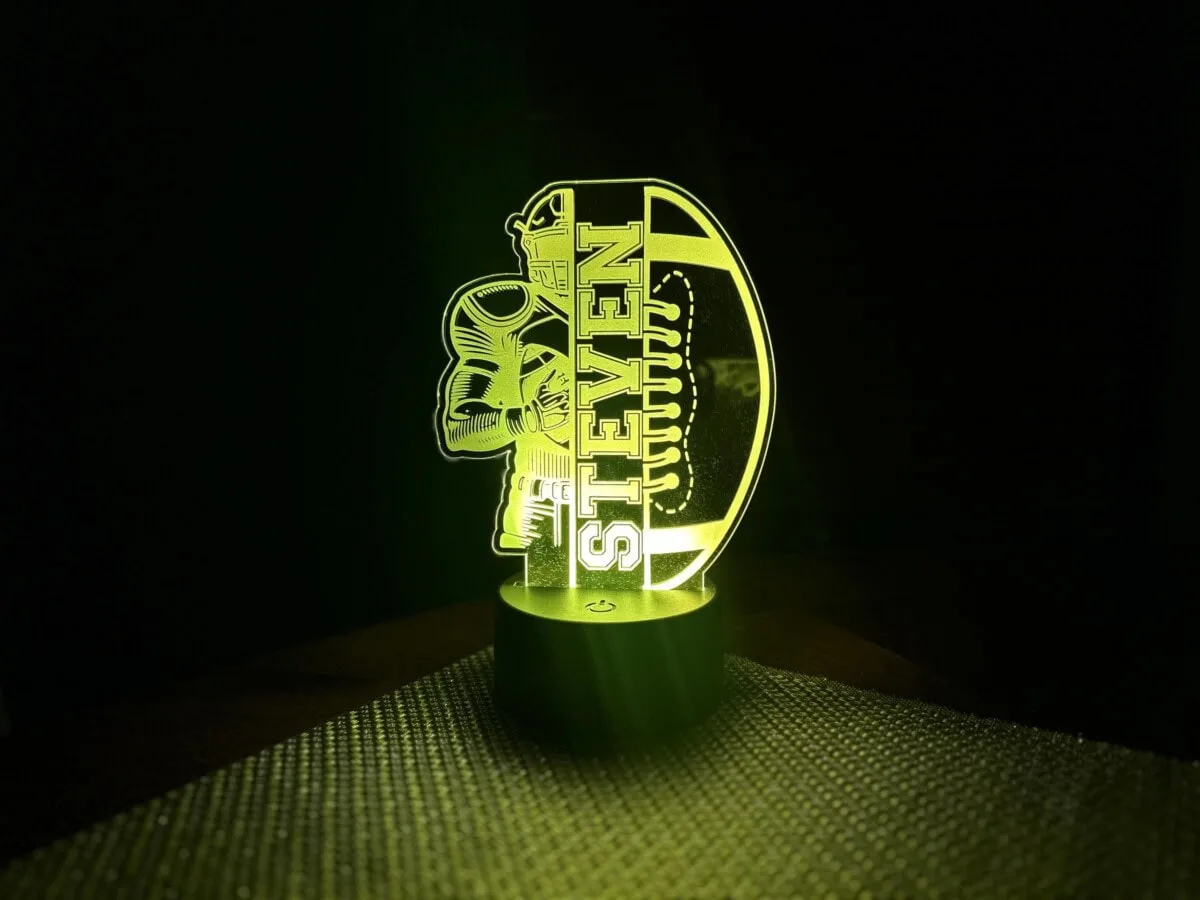 LED illuminated Shoreline Laser Designs logo with skull and text.